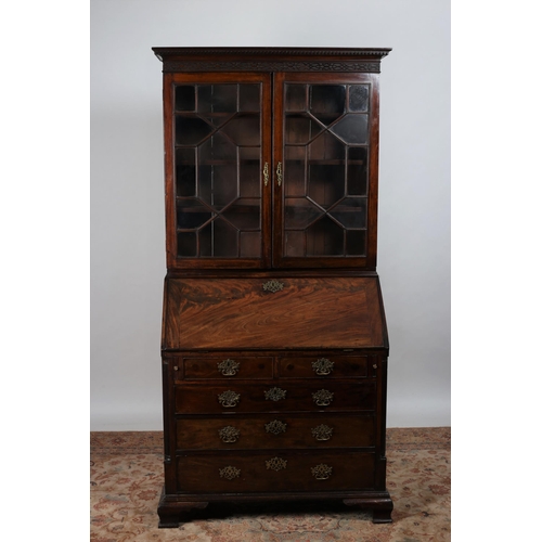 6 - A GEORGIAN MAHOGANY CROSSBANDED BUREAU BOOKCASE the dentil moulded and blind fretwork cornice above ... 