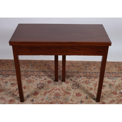 63 - A GEORGIAN MAHOGANY FOLDOVER SUPPER TABLE of rectangular outline the hinged top above a moulded apro... 