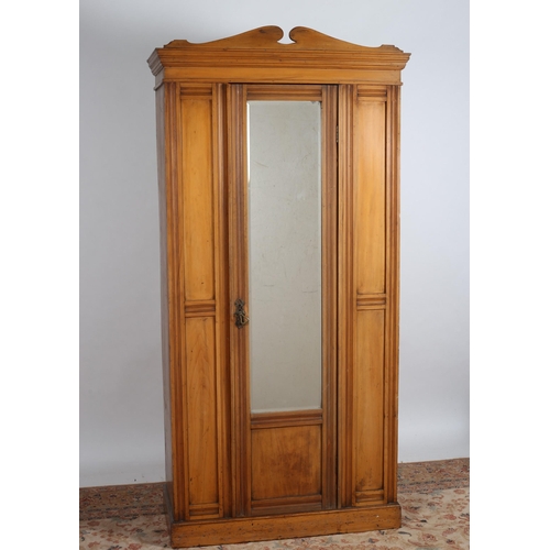 65 - A VINTAGE SATIN BIRCH WARDROBE the moulded cornice above a bevelled glazed mirrored door containing ... 