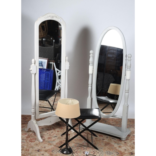 711 - TWO CONTINENTAL PAINTED CHEVAL MIRRORS each with a moulded frame raised on baluster supports on moul... 