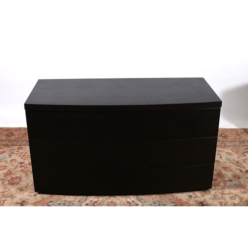 720 - A STAINED EBONISED CHEST BY POLIFORM the rectangular bowed outline the shaped top above three long g... 