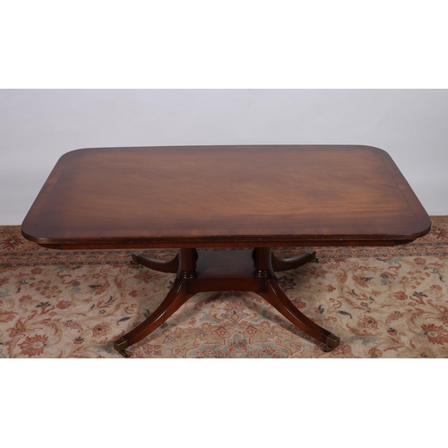 75 - A MAHOGANY CROSSBANDED COFFEE TABLE of rectangular outline with reeded rim raised on quadruped ring ... 