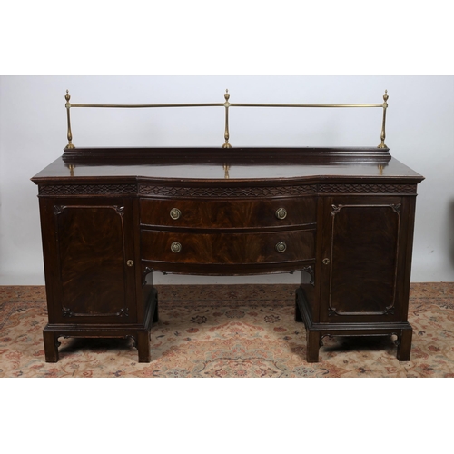 8 - AN EDWARDIAN MAHOGANY SIDEBOARD of rectangular bowed outline the shaped top with brass gallery above... 