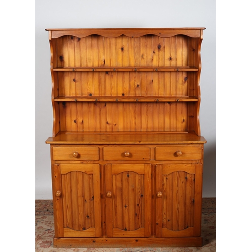 829 - A VINTAGE PINE OPEN FRONT DRESSER of rectangular outline the moulded cornice above three open shelve... 