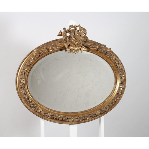 840 - A CONTINENTAL GILT FRAME MIRROR the oval bevelled glass plate within a foliate decorated frame with ... 