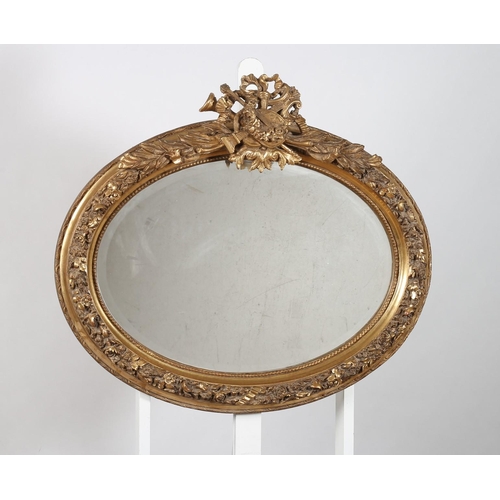 841 - (ensuite to previous lot) A CONTINENTAL GILT FRAME MIRROR the oval bevelled glass plate within a fol... 