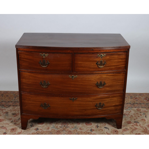 86 - A GEORGIAN MAHOGANY CHEST of demi lune outline the shaped top with reeded rim above two short and tw... 