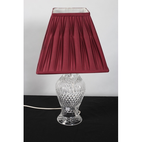 867 - A WATERFORD CUT GLASS TABLE LAMP of baluster form raised on a circular foot with pleated shade 
53cm... 