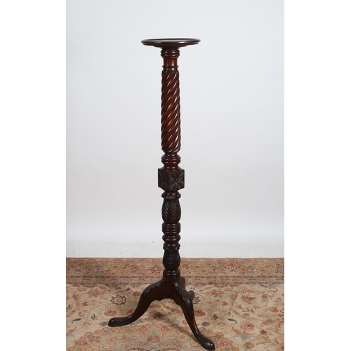 79 - A 19TH CENTURY MAHOGANY TORCHERE the circular dish top above a spiral twist and foliate carved colum... 