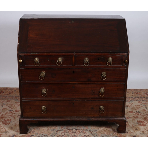 65 - A GEORGIAN MAHOGANY BUREAU the rectangular top above a hinged writing slope containing arrangement o... 