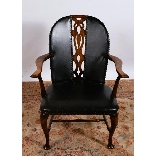 88 - A VINTAGE MAHOGANY AND HIDE UPHOLSTERED ELBOW CHAIR the shaped back with pierced vertical splat and ... 