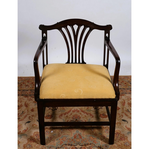 96 - A GEORGIAN MAHOGANY ELBOW CHAIR the shaped top rail above a pierced vertical splat with upholstered ... 