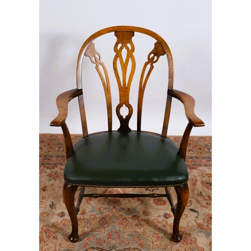 98 - A VINTAGE MAHOGANY AND UPHOLSTERED ARMCHAIR the arched top rail above pierced vertical splats and up... 