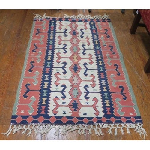 148 - A KILIM WOOL RUG the light pink, indigo and beige ground with central panel with geometric designs w... 