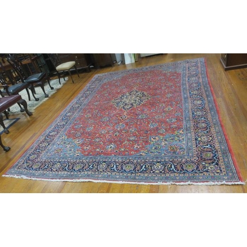 147 - A PERSIAN SAROUGH WOOL RUG the light red, indigo and light blue ground with central panel filled wit... 