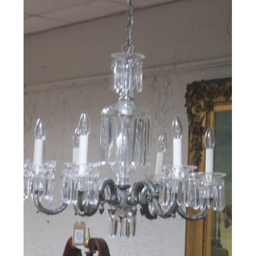 154 - A CUT GLASS AND BRONZED SIX BRANCH CHANDELIER with foliate scroll arms hung with faceted pendants 
6... 