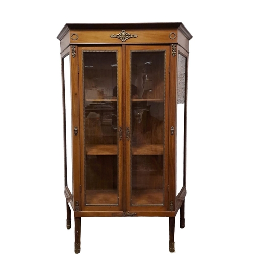 181 - A CONTINENTAL MAHOGANY AND GILT BRASS MOUNTED CHINA DISPLAY CABINET of rectangular shaped outline th... 