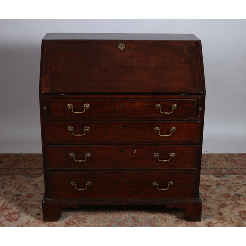 182 - A GEORGIAN MAHOGANY BUREAU of rectangular outline the shaped top above a hinged writing slope contai... 