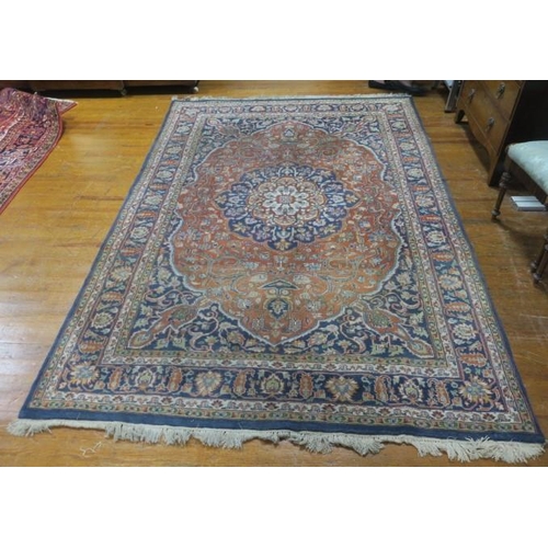 264 - A TIBRIZ WOOL RUG the indigo and wine ground with central panel filled with stylised flowerheads, pa... 