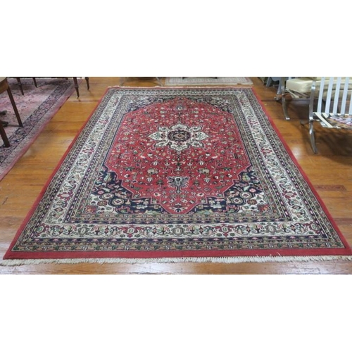 265 - A KASHAN WOOL RUG the red, indigo and cream ground with central panel filled with stylised flowerhea... 