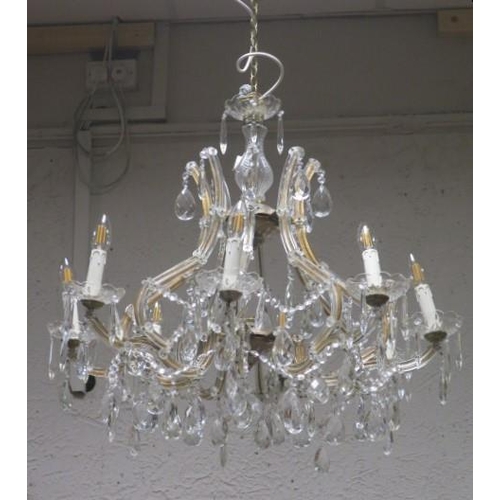 268 - A CONTINENTAL CUT GLASS EIGHT BRANCH OPEN WORK CHANDELIER hung with faceted chains and pendent drops... 