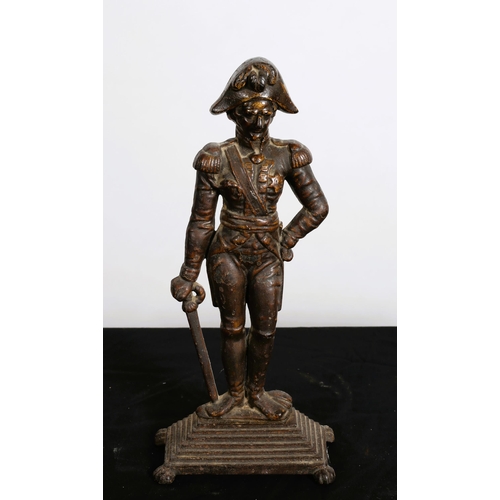 305 - A 19TH CENTURY CAST IRON DOOR STOP modelled as Napoleon shown standing on a rectangular stepped base... 