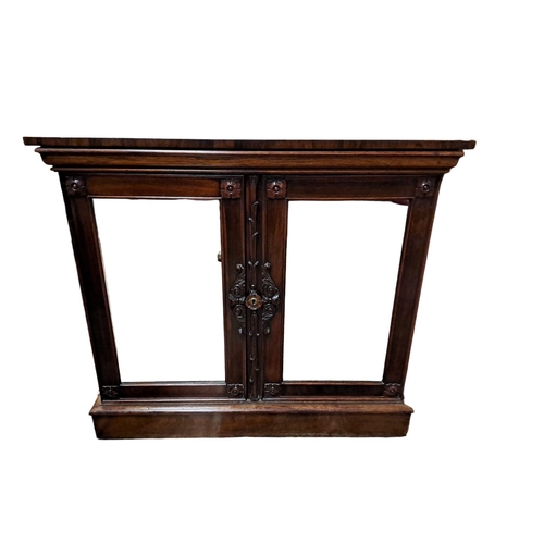 440 - A 19TH CENTURY ROSEWOOD SIDE CABINET of rectangular outline the shaped top above a pair of foliate c... 