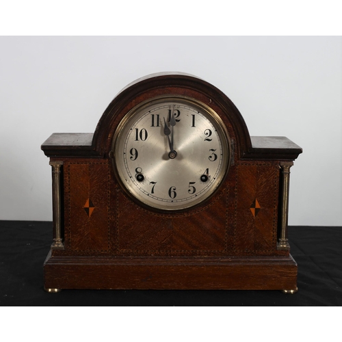 570 - A VINTAGE MAHOGANY INLAID MANTEL CLOCK of rectangular arched form the shaped case with silvered dial... 