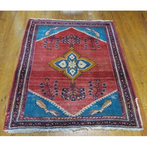 579 - AN ORIENTAL WOOL RUG the wine turquoise ground with central panel filled with stylised flowerheads a... 