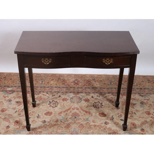 639 - A HEPPLEWHITE DESIGN MAHOGANY SIDE TABLE of serpentine outline the shape top above two frieze drawer... 