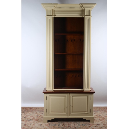 605 - A CHALON PINE AND PAINTED OPEN FRONT BOOKCASE of inverted breakfront outline the dentil moulded corn... 