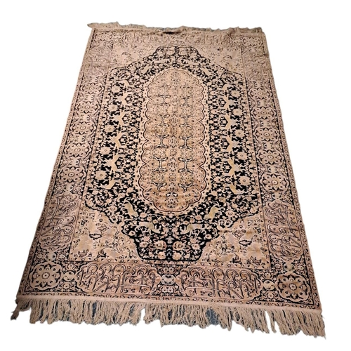 741 - AN IRANIAN WOOL RUG the indigo and wine ground filled with serrated panels, flowerheads and hooks wi... 