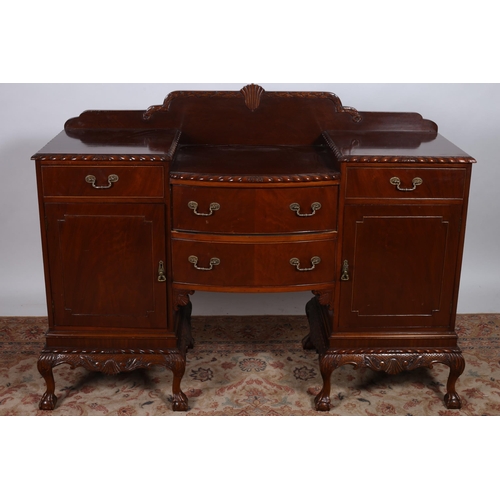 758 - A CHIPPENDALE DESIGN MAHOGANY SIDEBOARD of rectangular bowed outline the stepped top with two frieze... 