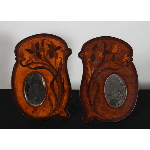 767 - A PAIR OF POKERWORK MARQUETRY FRAMED MIRRORS each with an oval plate 
42cm (h) x 22cm (w)