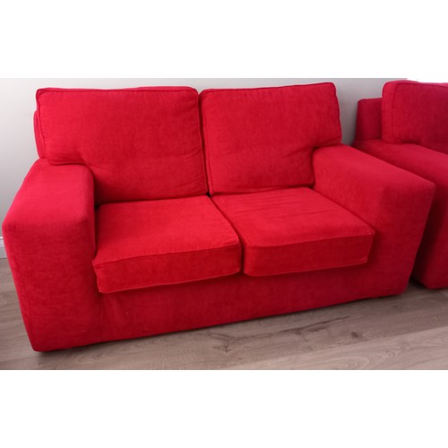 807 - A RED UPHOLSTERED SETTEE of rectangular outline with loose cushions 92cm (h) 164cm (w) 85cm (d)