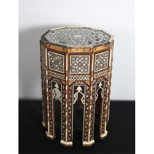 101 - A VINTAGE EGYPTIAN PEDESTAL TABLE of octagonal outline with mother of pearl inlaid panels 
51cm (h) ... 