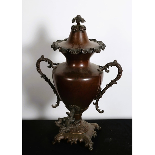 107 - A 19TH CENTURY COPPER SAMOVAR of urn form with foliate scroll handles on a stylised foliate base 
57... 