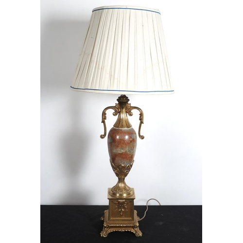 108 - A VINTAGE GILT METAL AND MARBLE TABLE LAMP of urn form with scroll handles raised on a rectangular b... 