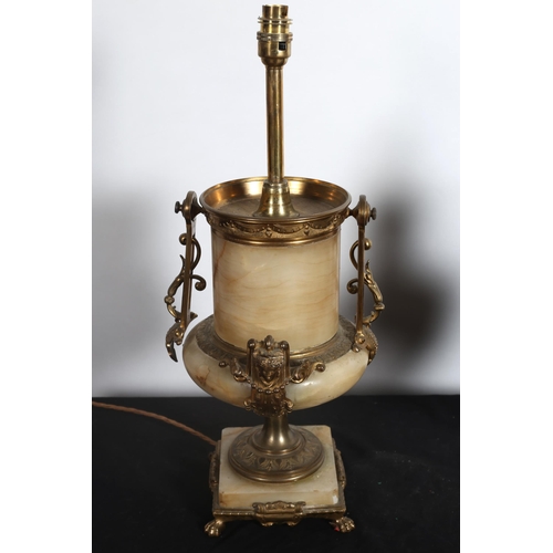 110 - AN ALABASTER AND GILT BRASS TABLE LAMP of urn form with figural masks and pierced handles on platfor... 