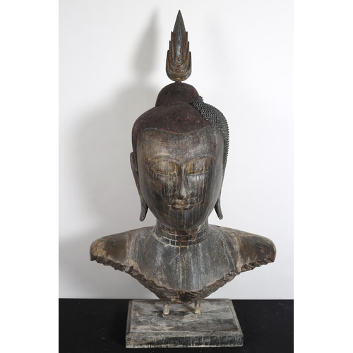 119 - A CAMBODIAN CARVED WOOD HEAD AND SHOULDER BUST of a Buddha on a rectangular platform 
119cm (h) x 69... 