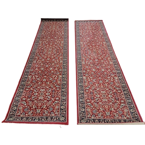 146 - A PAIR OF WOOL RUNNERS the wine ground with central floral panel within a conforming border
Each 349... 