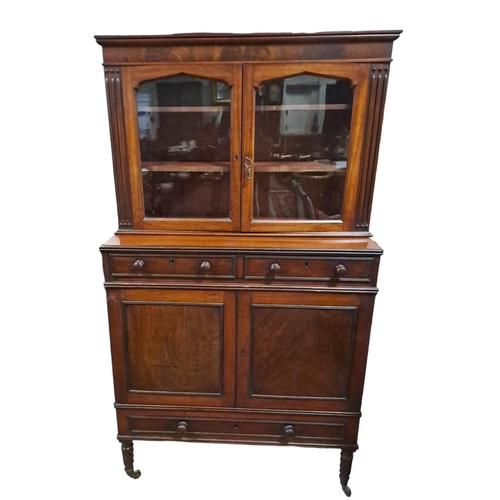 158 - A 19TH CENTURY MAHOGANY BOOKCASE the moulded cornice above a pair of glazed doors containing shelves... 