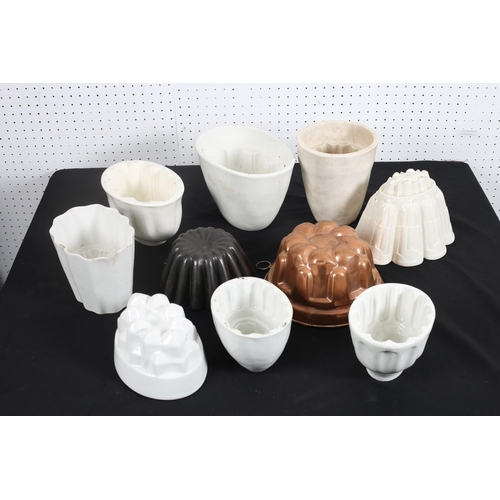 161 - A COLLECTION OF EIGHT CHINA JELLY MOULDS   to include a 2nd period Belleek example, a copper jelly m... 