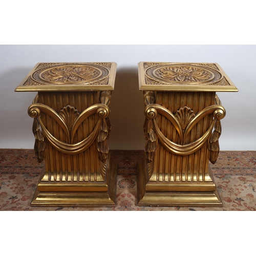 165 - A PAIR OF CONTINENTAL CARVED GILTWOOD PEDESTALS each of square outline the shaped tops with glass pa... 