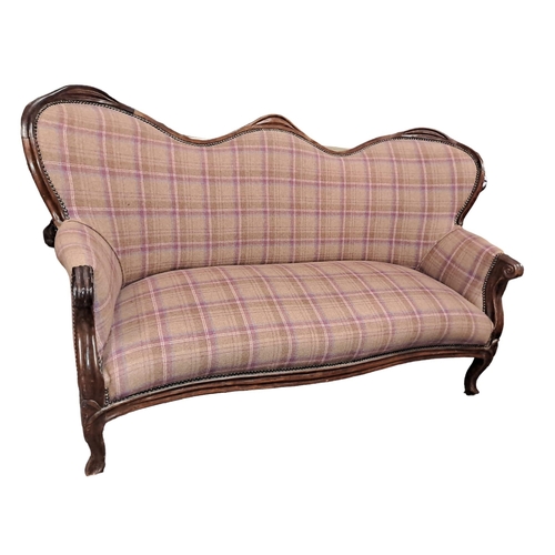 169 - A 19TH CENTURY CONTINENTAL MAHOGANY AND UPHOLSTERED SETTEE the serpentine top rail above an upholste... 