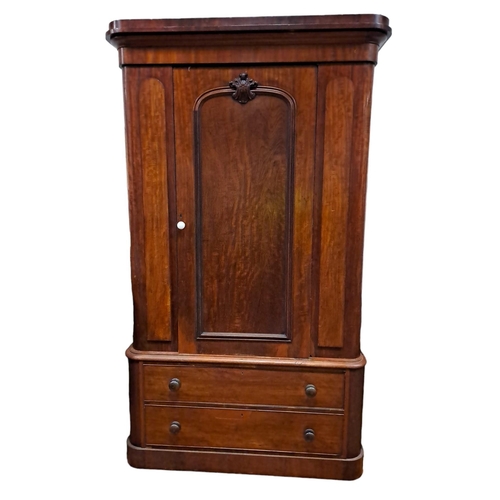 170 - A 19TH CENTURY MAHOGANY WARDROBE the moulded cornice above a panel door with applied carving contain... 