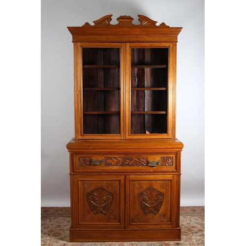 173 - A 19TH CENTURY CARVED WALNUT SECRETAIRE BOOKCASE the architectural pediment above a pair of glazed d... 