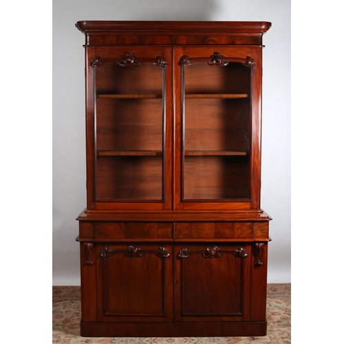 174 - A 19TH CENTURY MAHOGANY LIBRARY BOOKCASE the moulded cornice above a pair of glazed doors containing... 