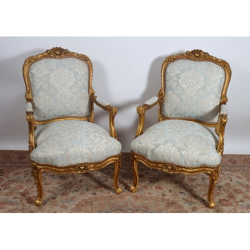 177 - A PAIR OF CONTINENTAL GILTWOOD AND UPHOLSTERED ARMCHAIRS each with a foliate and flowerhead carved t... 