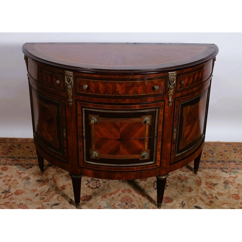 190 - A CONTINENTAL KINGWOOD AND GILT BRASS MOUNTED SIDE CABINET of demi lune outline the shaped top above... 